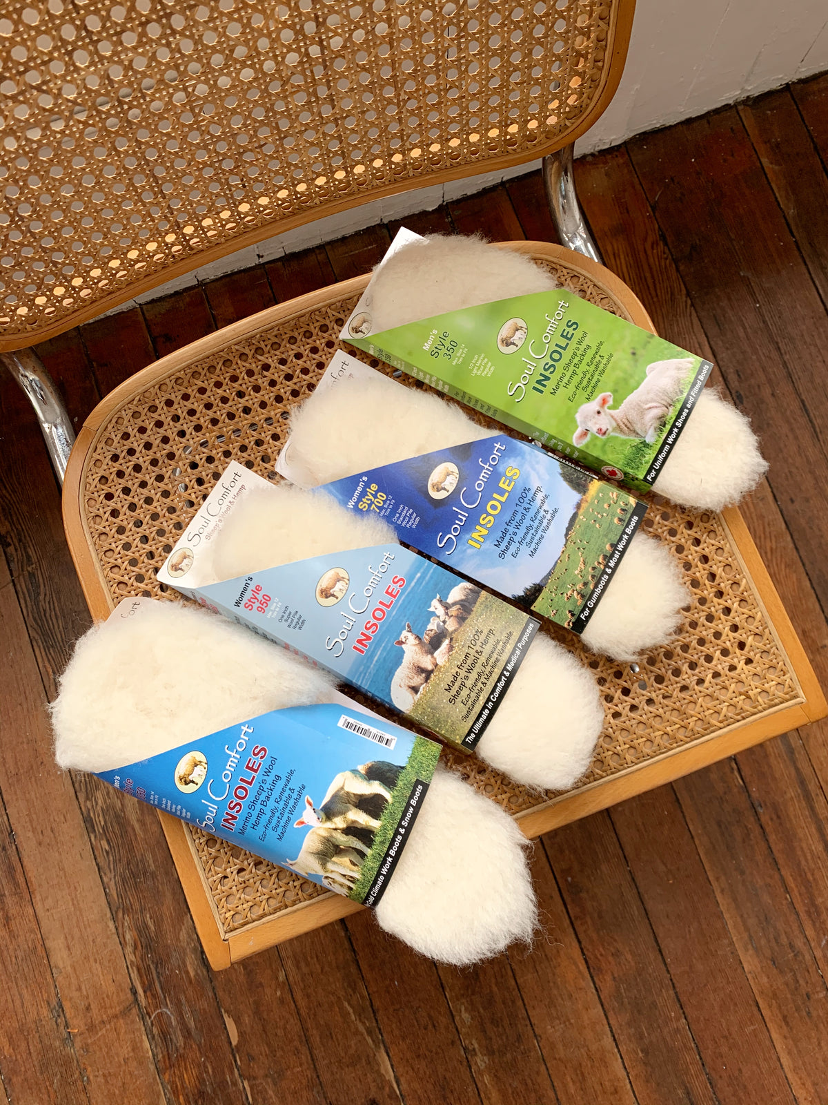 Packaged wool and hemp insoles designed for shoes and boots, displayed on a chair.